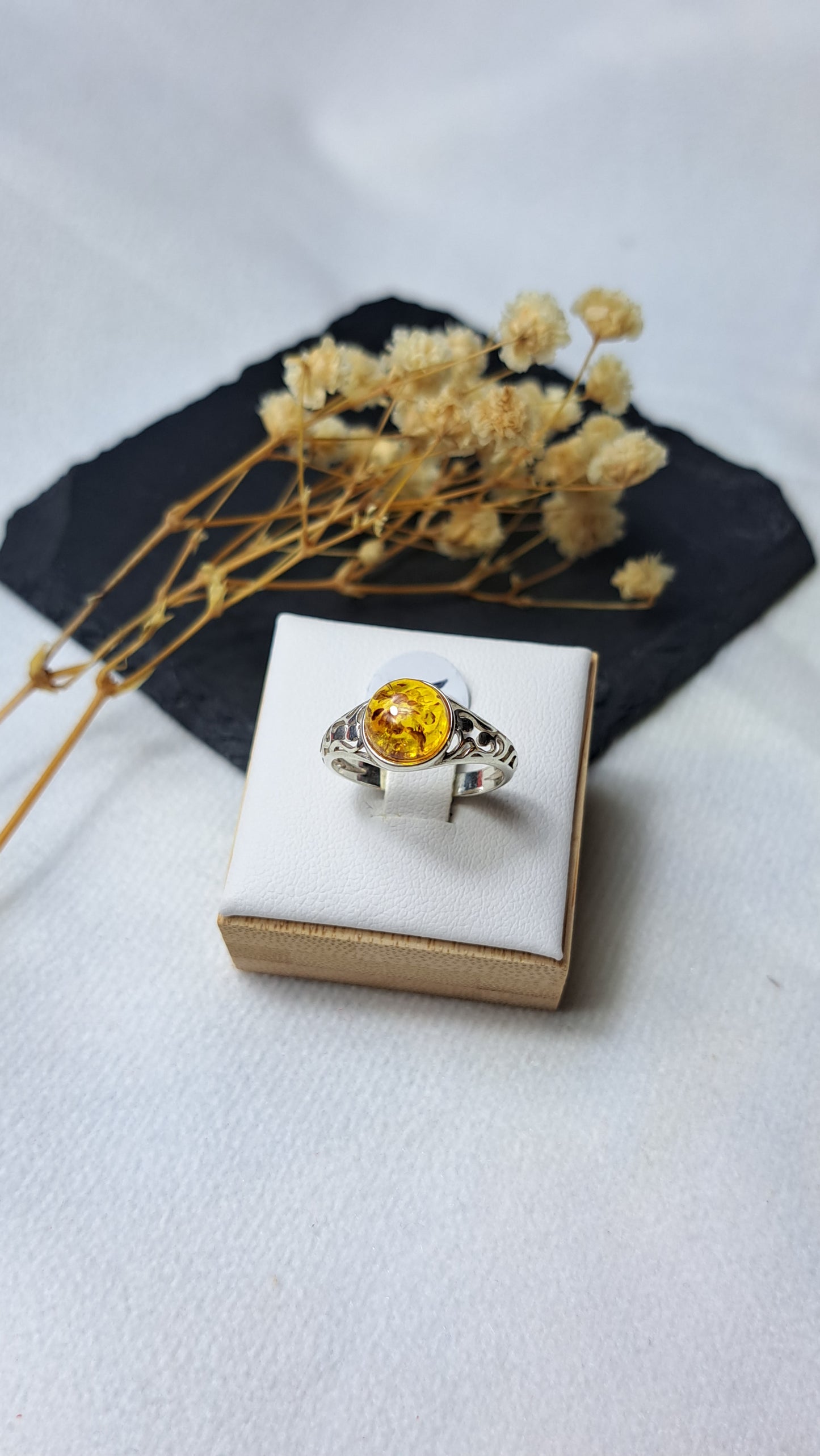 Cognac amber cabachon framed with cut-out swirl shoulders