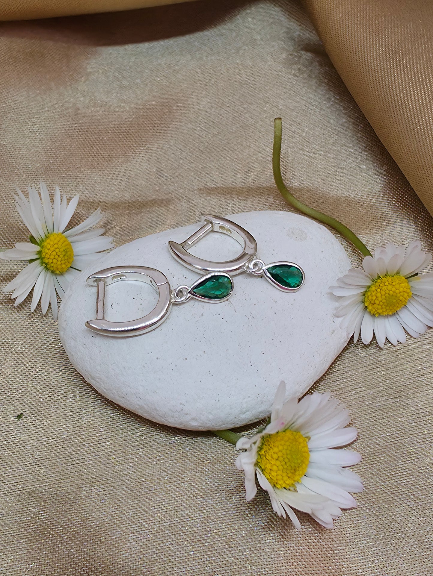Horseshoe huggie hoop with a flat emerald teardrop charm