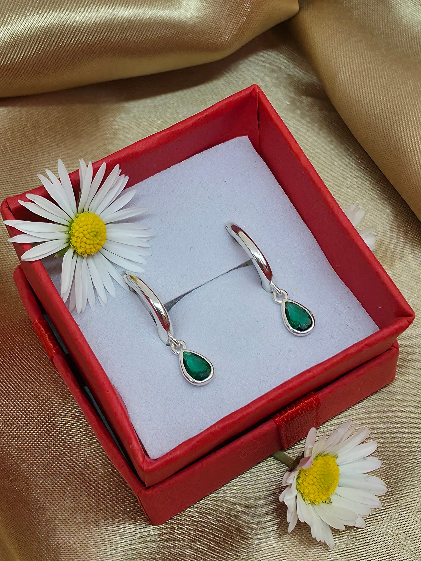 Horseshoe huggie hoop with a flat emerald  teardrop charm