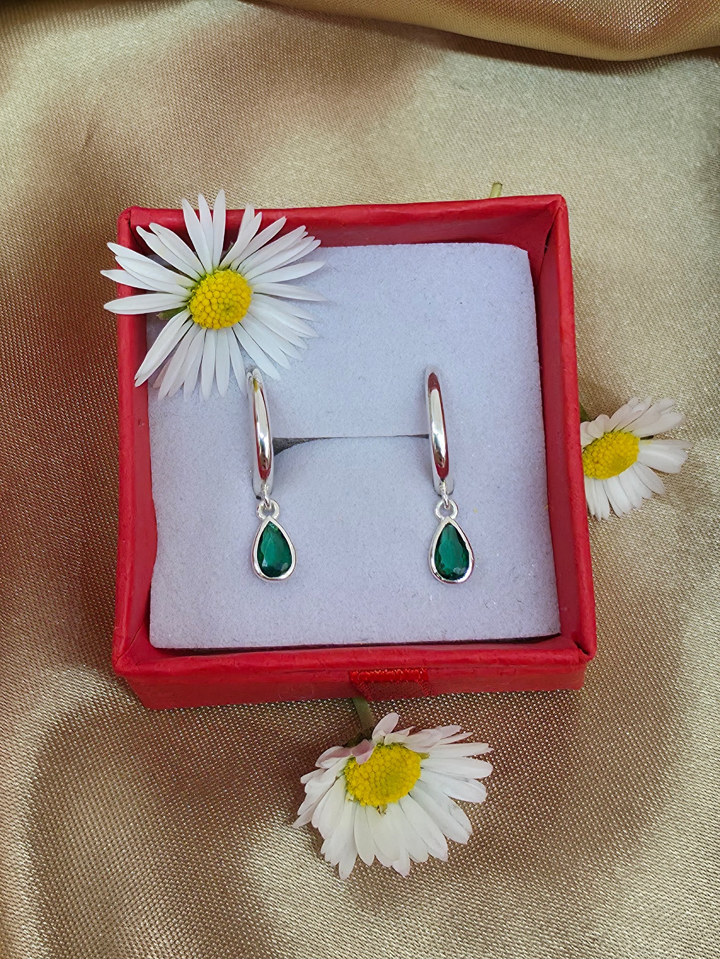 Horseshoe huggie hoop with a flat emerald  teardrop charm